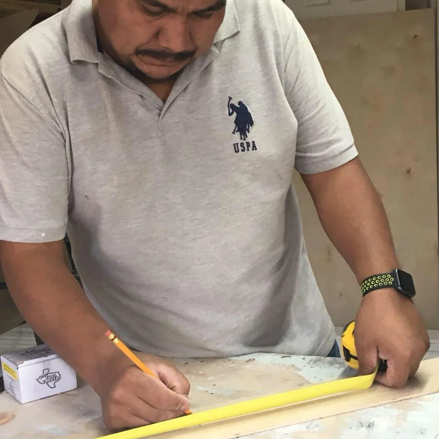 Wilfrido Ramirez measuring a carpentry project