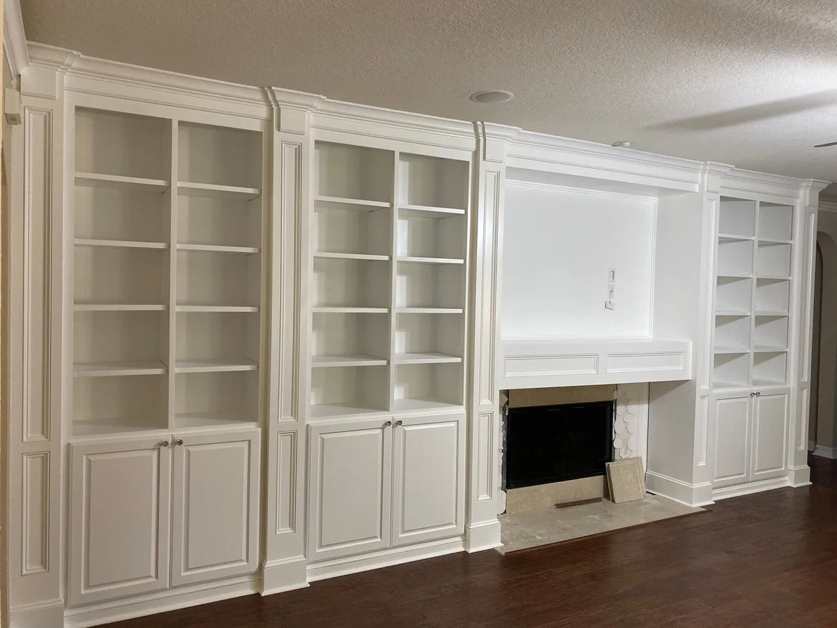 White custom library built-ins with cabinets and shelves