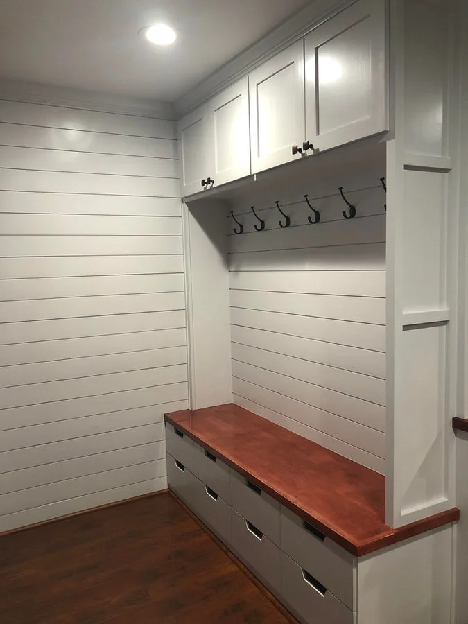 Custom mudroom bench, drawers, hooks, and upper cabinets
